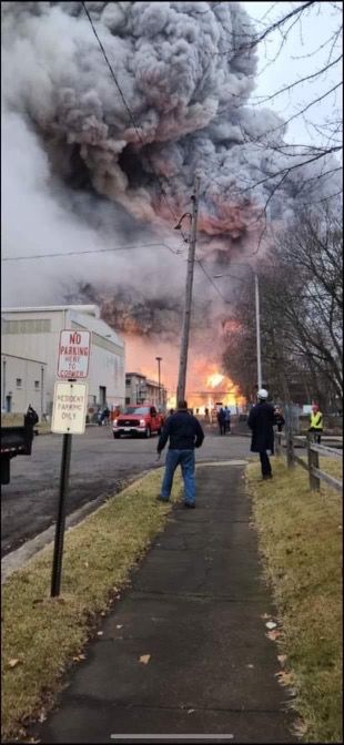Firemen and workers outside of Carus Chemical in LaSalle, Illinois, as smoke and fire billow after the chemical factory exploded0 January 11, 2023 in La Salle, Illinois   